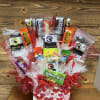 Gift basket of assorted candy and jerky in a heart-patterned box