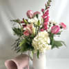 A delicate blend of rosy hues and fresh greenery in a timeless