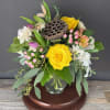 This arrangement of roses, lilies and tulips is sure to bring sunshine