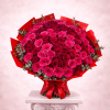 Large bouquet of pink and red roses wrapped in red paper