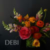 Bouquet of orange and pink flowers in a glass vase