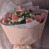 A delicate bouquet of blush pink roses paired with soft white blooms
