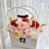 A vibrant preserved flower arrangement featuring 3 bold red roses and 3