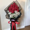 An elegant arrangement of fresh red roses, accompanied by delicate gypsophila that