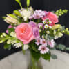 Bouquet of pink and lavender flowers in a glass vase