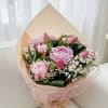 A luxurious and feminine spring bouquet featuring lush pink peonies and vibrant