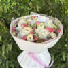 An elegant floral arrangement featuring a blend of pure white and vibrant