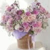 A lush, pastel-filled basket that reads like a lavender-scented daydream - this