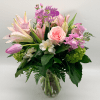 Soft, romantic, and effortlessly graceful, this garden-style arrangement features  lilies, roses