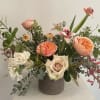 Flemish design in a clay pot filled with garden roses and tulips.