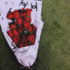 Bouquet of red roses wrapped in white paper with a black ribbon