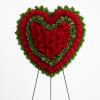 Heart-shaped floral standing spray with red roses and red and green carnations