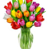 Colorful tulips arranged in a clear glass vase