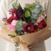 A soft and romantic hand-tied bouquet designed with fresh seasonal blooms in