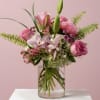 A light, airy arrangement designed with graceful movement and soft texture. Layered
