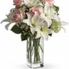 A modern and stylish arrangement featuring elegant lilies and soft pink roses