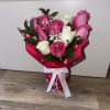 beautiful fuchsia and white roses, glass vase with pearl ribbon