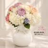 An abundant luxury arrangement featuring blush roses, premium garden roses, white hydrangea