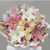 Pink and white bouquet with lilies and roses wrapped in pastel paper