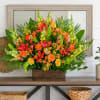 Bright mixed bouquet with orange and red flowers in a wooden box