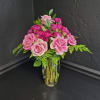 A lush cluster of blush pink roses and vibrant magenta spray roses