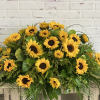 Large sunflower arrangement with greenery on a wooden table