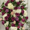 Large standing spray of pink, purple, and white roses with white hydrangeas