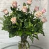Pink roses arranged in a clear glass vase