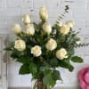 Bouquet of cream roses in a clear glass vase