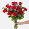 Handheld bouquet of red roses with eucalyptus greenery