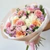 Hand-tied bouquet of pink, peach, and white roses with pastel filler flowers