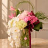 A luxurious floral arrangement featuring cascading orchids, premium roses, hydrangeas, and tropical