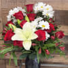 A striking contrast of deep red roses and crisp white blooms makes