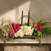 An elegant centerpiece featuring premium roses, hydrangeas, chrysanthemums, and lush greenery paired
