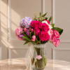 An elegant arrangement featuring premium roses, tulips, hydrangeas, and fresh greenery designed