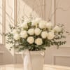 A sophisticated design featuring premium white roses, fresh eucalyptus, and natural branches