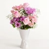 Soft pink roses and lavender-purple blooms come together in this pastel garden
