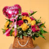Bursting with cheerful sunflowers, golden roses, and vibrant pink accents, this arrangement