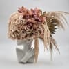 Blush rose and orchid arrangement on a mannequin bust with dried grasses