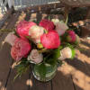 Lush pink peonies take center stage in this romantic flower arrangement, paired