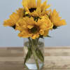 Bouquet of yellow sunflowers in a clear glass vase