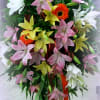 Tall standing spray of lilies and gerbera daisies in pink, white, and yellow