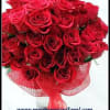 Bouquet of red roses wrapped in red mesh ribbon