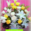 Bouquet of yellow and white roses with white lilies in a vase