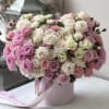 Pink and white rose bouquet in a round pink box with ribbon
