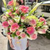 Large pink and white flower arrangement with gerberas, roses and calla lilies in a white hat box