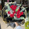 one dozen long stemmed red Ecuadorian roses with baby's breathe and fragrant