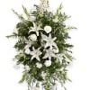 White lilies and carnations in a standing spray on an easel