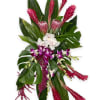 Tropical bouquet with pink ginger, orchids, and large green leaves