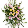 Standing floral spray with pink, yellow, and white flowers on an easel